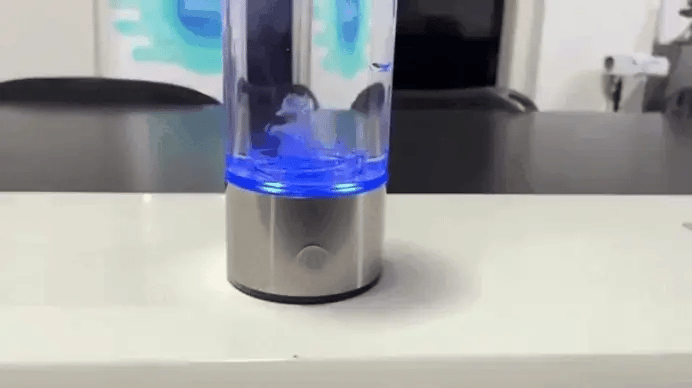 Person measuring hydrogen concentration in Portable Hydrogen Water Generator during active electrolysis process