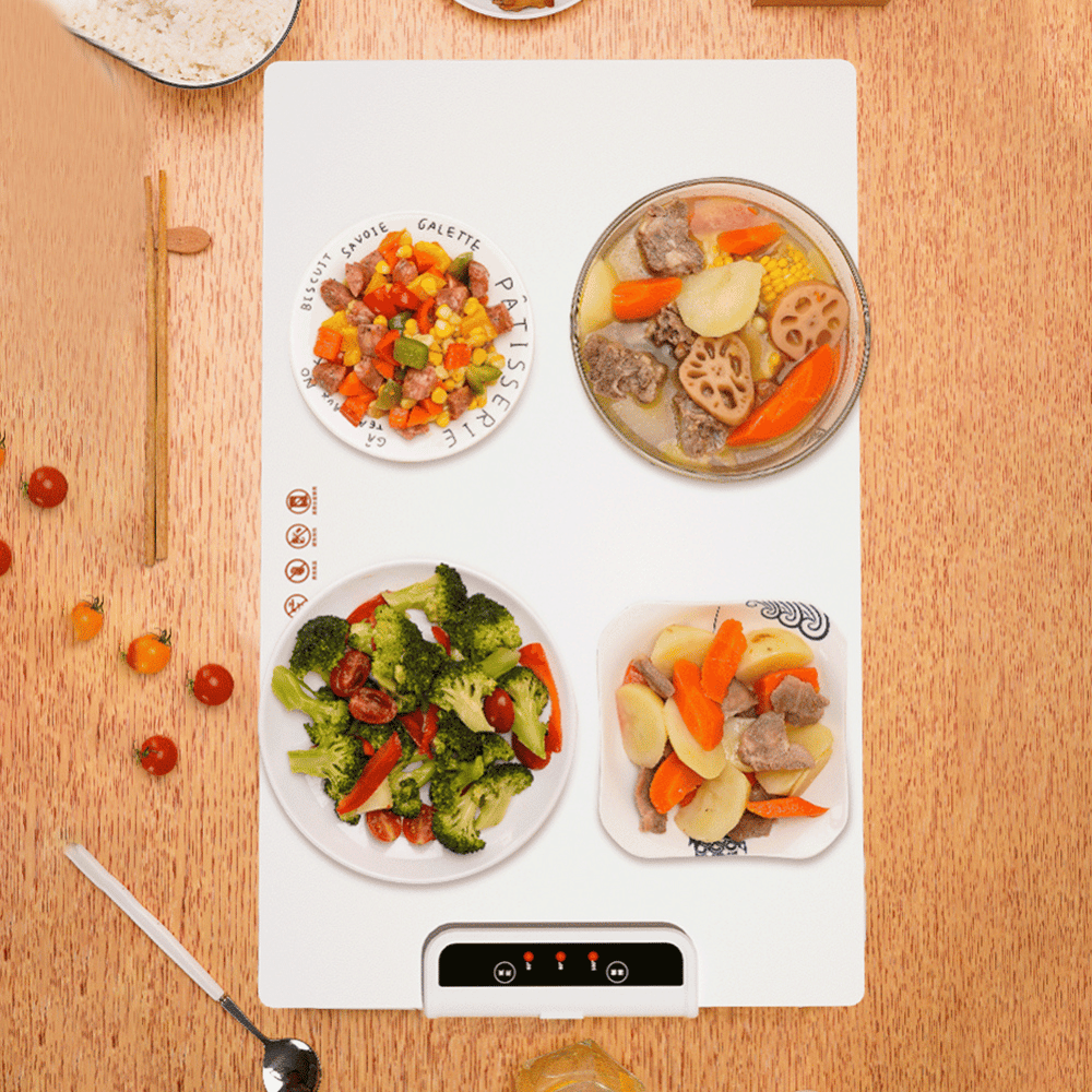 Top view of foldable food warmer heating four plates of food, showcasing spacious surface.