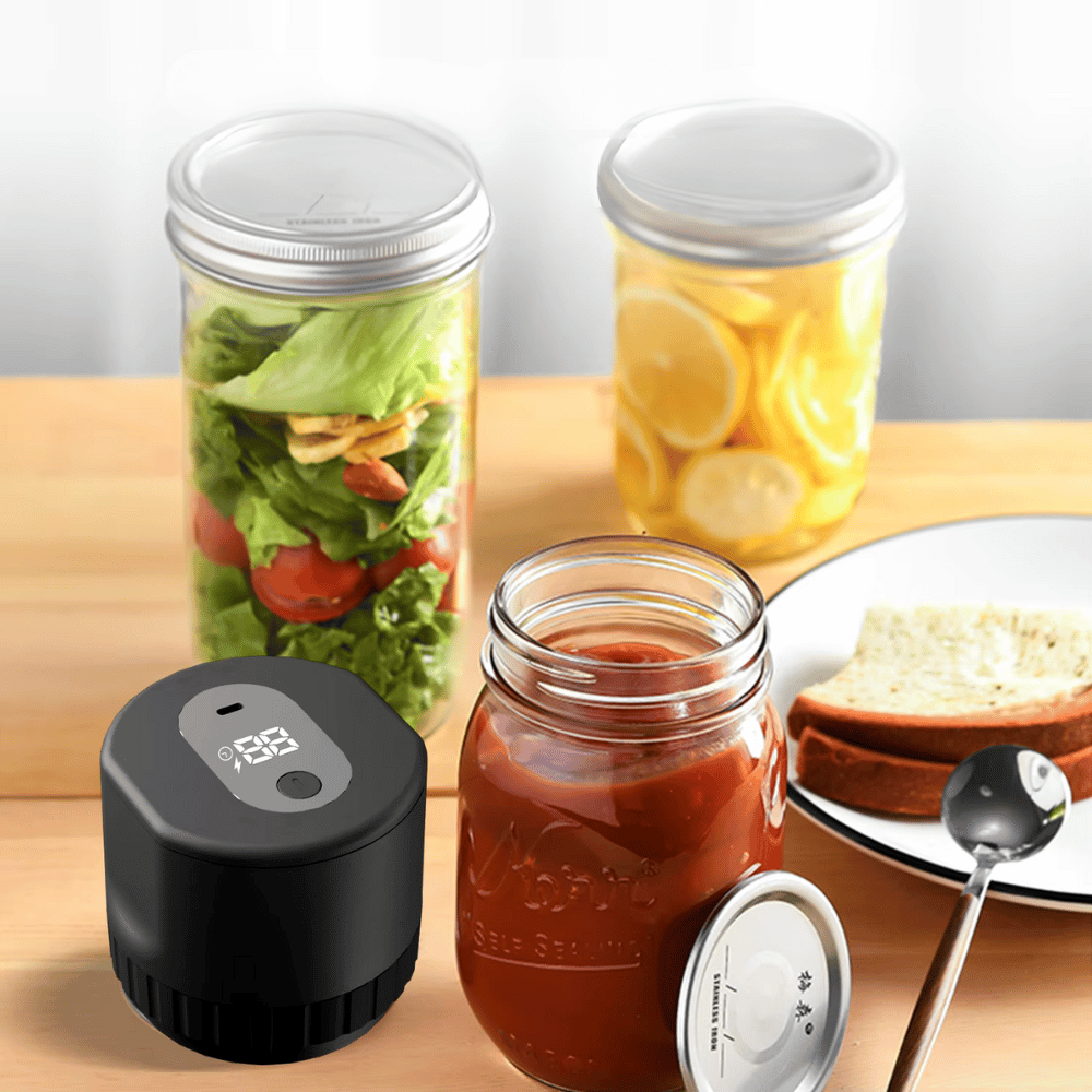 Electric vacuum jar sealer next to jars of salad and sauces on kitchen counter